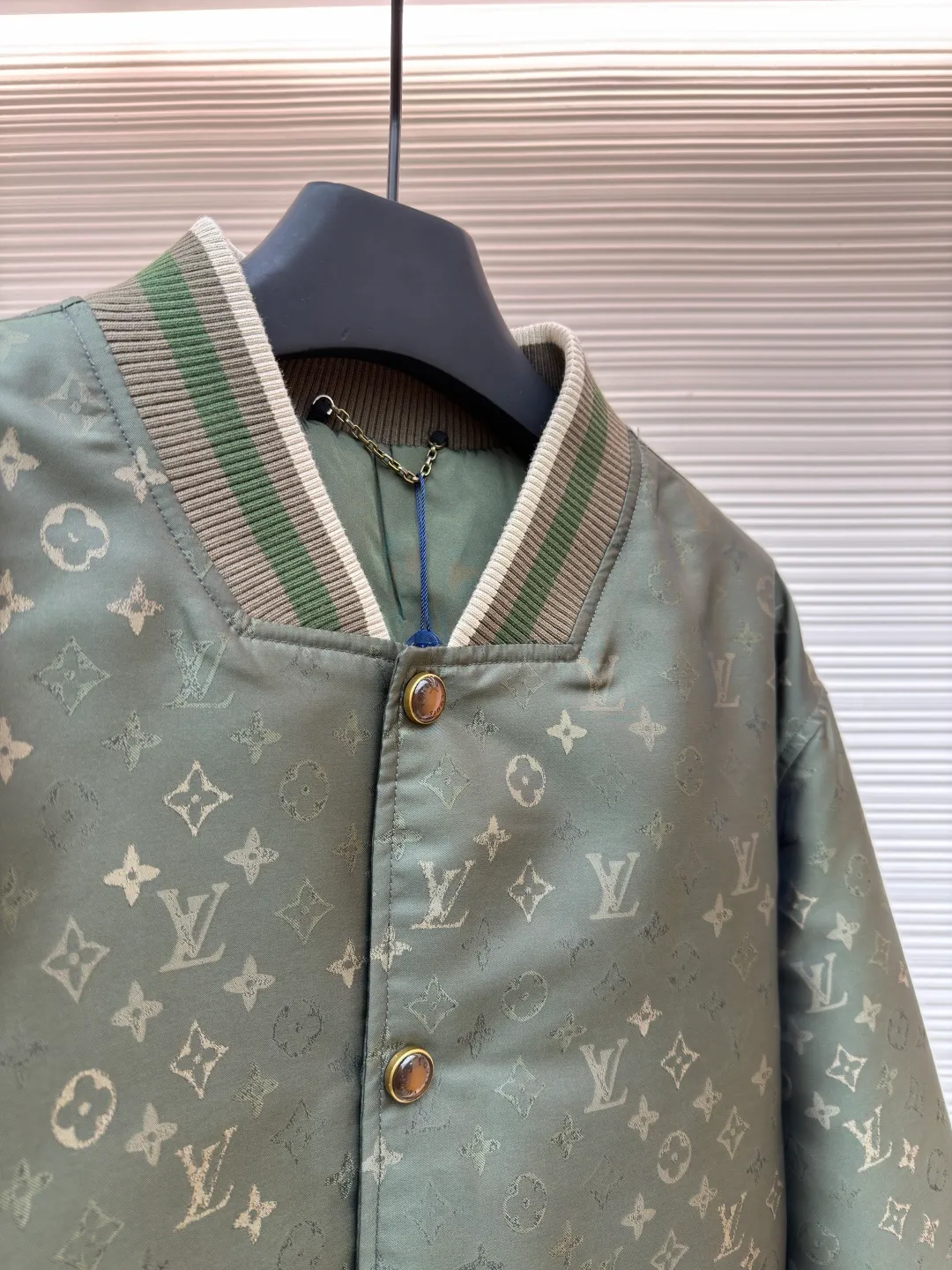 LOUIS VUITTON striped trim jacquard long-sleeved bomber jacket ●Original version: purchased and developed by 29237 ●Item number: 1682087-C05 ●Fabric: nylon fabric ●Technology: jacquard production ●Color: green ●Version: fitted version ●Weight: about 800 grams ●Size: S-M-L-XL ●Description: This Louis Vuitton baseball jacket is made of high-density jacquard satin fabric. The base is a polyester fiber blended material with a military green matte texture. The classic Monogram presbyopia pattern is woven into the fabric in the form of dark patterns of the same color through a special weaving process. The pattern texture is three-dimensional and presents a delicate illusion luster with the angle of light. High-precision jacquard weaving technology is used in the process to ensure the integrity and delicacy of the pattern. The body adopts a single-row metal snap closure design. The metal buckles are matte and distressed to echo the color of the body. The ribbed collar, cuffs and hem are made of two-color knitting technology. The elastic ribs have both stiffness and comfort, and are pre-shrunk to prevent deformation. The overall cut is a loose oversize version, and the splicing uses a combination of flat seams and hemming techniques. The interior is supplemented by smooth overlock sewing. Every stitch is even and fine, which fully reflects the brand's exquisite garment production technology and detail control. The overall wiring is straight and delicate, the fabric is comfortable and soft, and the color is consistent without color difference. It can be matched with the same style to create a fashionable look and control various occasions. Customized accessories, complete with three standards, same style for men and women!